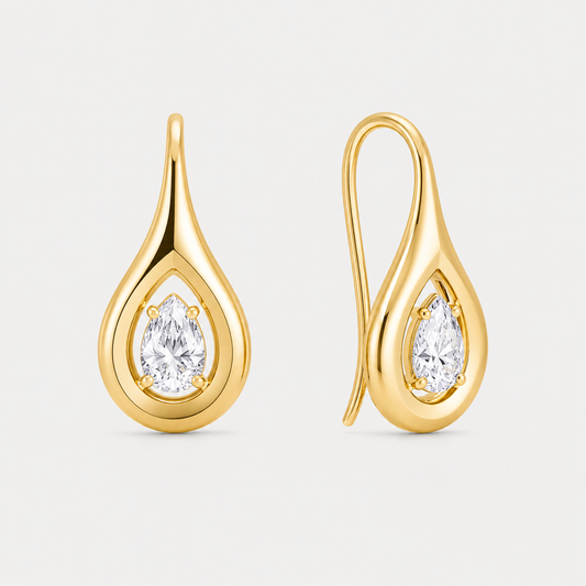 Gold teardrop-shaped earrings with clear gemstones on a light gray background
